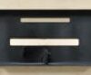 All lights include complete mounting hardware and are designed to be mounted anywhere on the wall so that the junction box does not need to be centered on the light. The slots on the top are used to screw to the wall and the bottom slots are for running the wires to the electrical boxes.