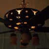 Night view showing the bottom housing illuminated and design cut outs around and under the fan.